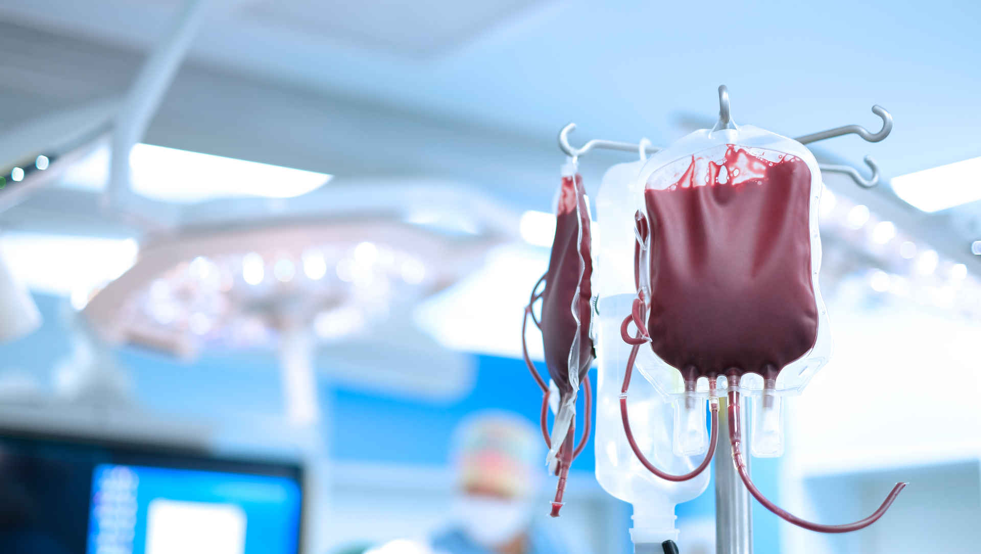 Two bags of red cells hanging on a stand